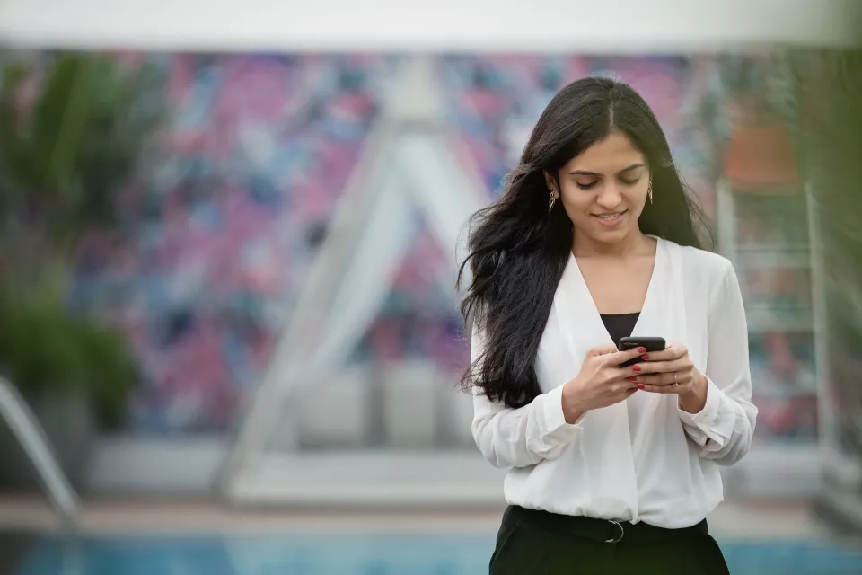 Smiling guest using a smartphone